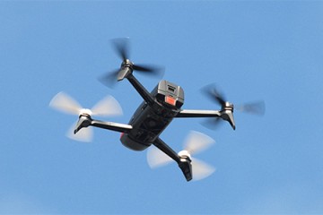 Quadrotor against blue sky