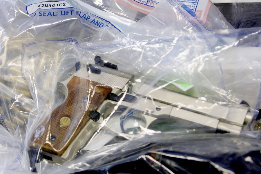 A handgun in an evidence bag
